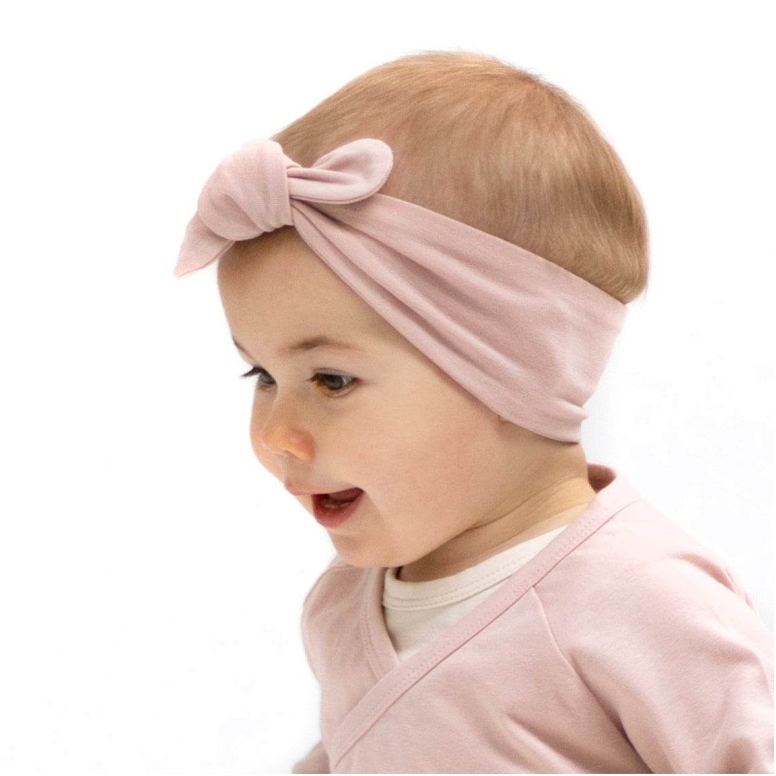 Baby girl wearing Kimono Bodysuit and Essential Baby Headband in Dusty Rose, designed by Burrow and Be