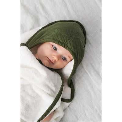 Baby wrapped in Olive Essential Baby Hooded Towel designed by Burrow and Be