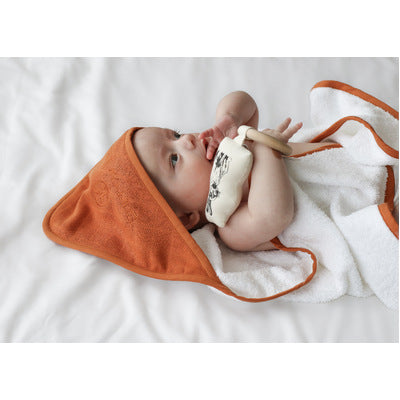 Baby wrappedi n Rust Essential Baby Hooded Towel designed by Burrow and Be and cuddling doll