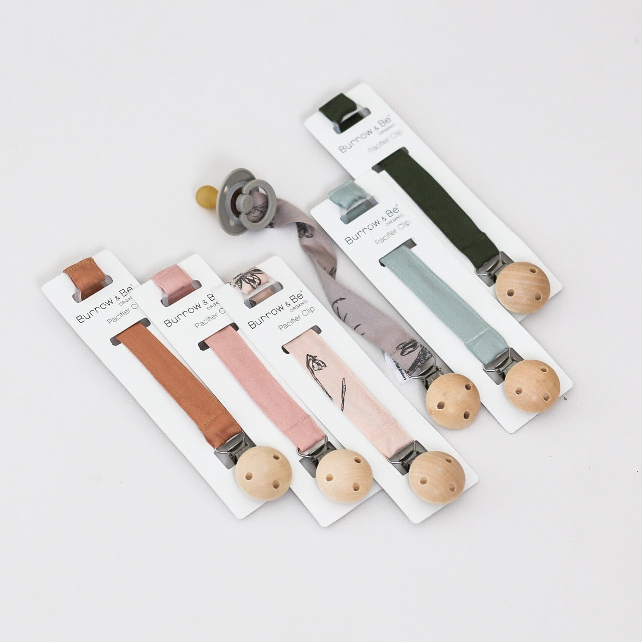 A colelction of 6 design of Essential Pacifier Clip designed by Burrow and Be