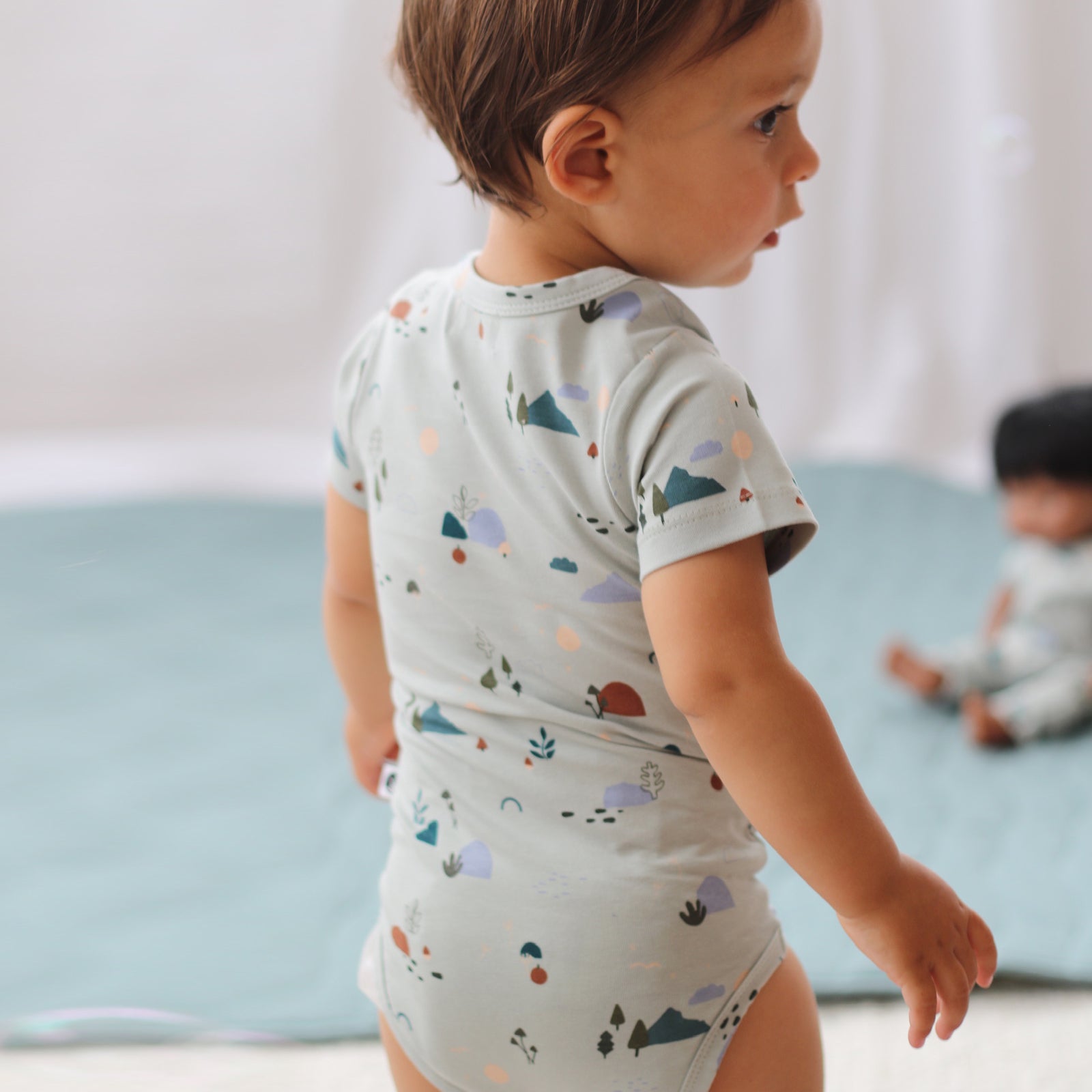 Baby boy wearing Garden Treasures Short Sleeve Bodysuit, all designed by Burrow and Be