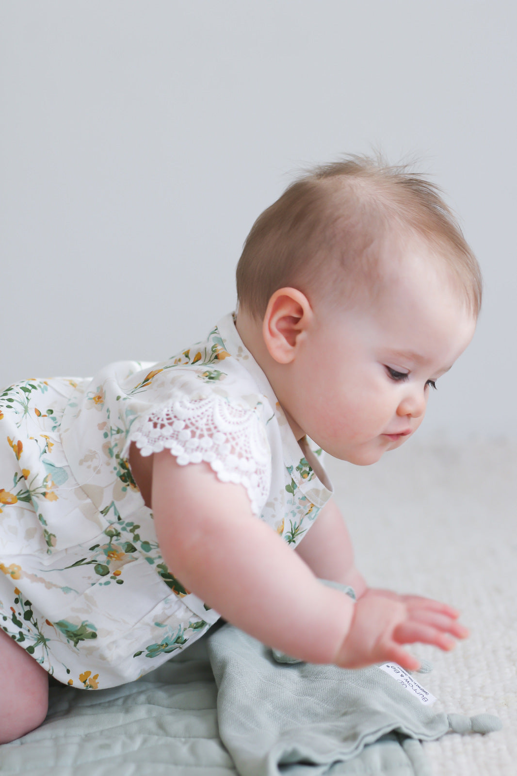 Crawling baby iwearing Burrow and Be Spring Melody Lace Sleeve Milly Romper