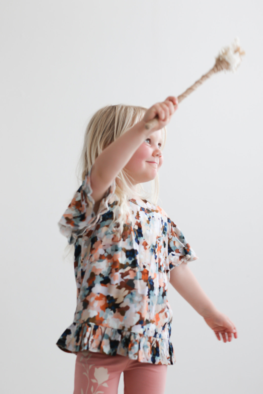 Girl wearing Doe Bike shorts and Delight Ella Top by Burrow and Be and waving wand