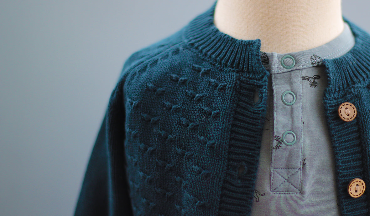 Mannequin wearing a Sage Alex Romper with Billie Knit Cardigan by Burrow and Be