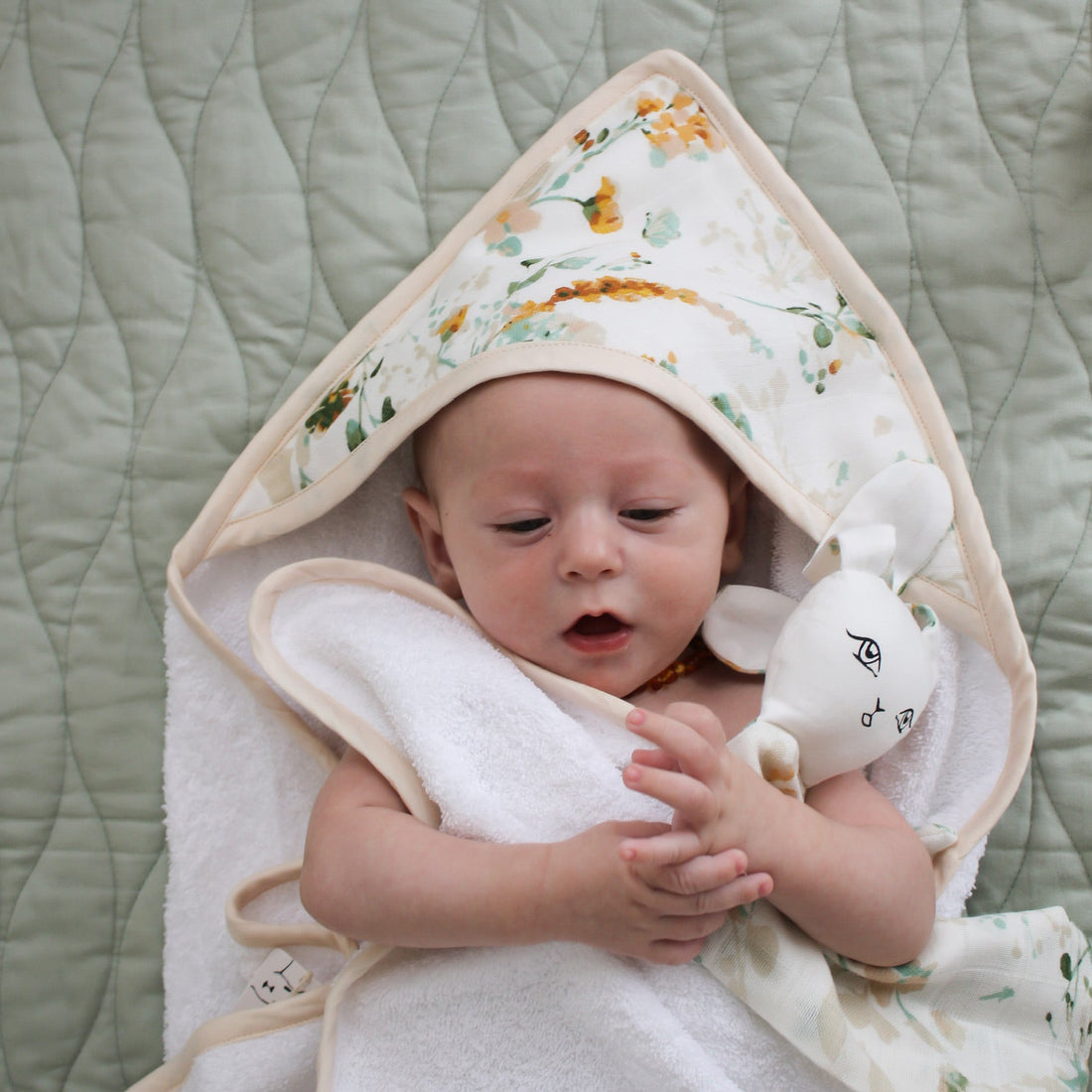 Baby wrapped in a soft organic cotton hooded towel after a bath, Burrow and Be Singapore