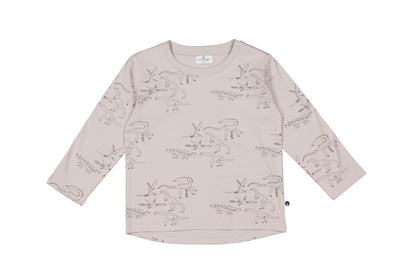 Beige long-sleeve shirt with dinosaur prints on a white background