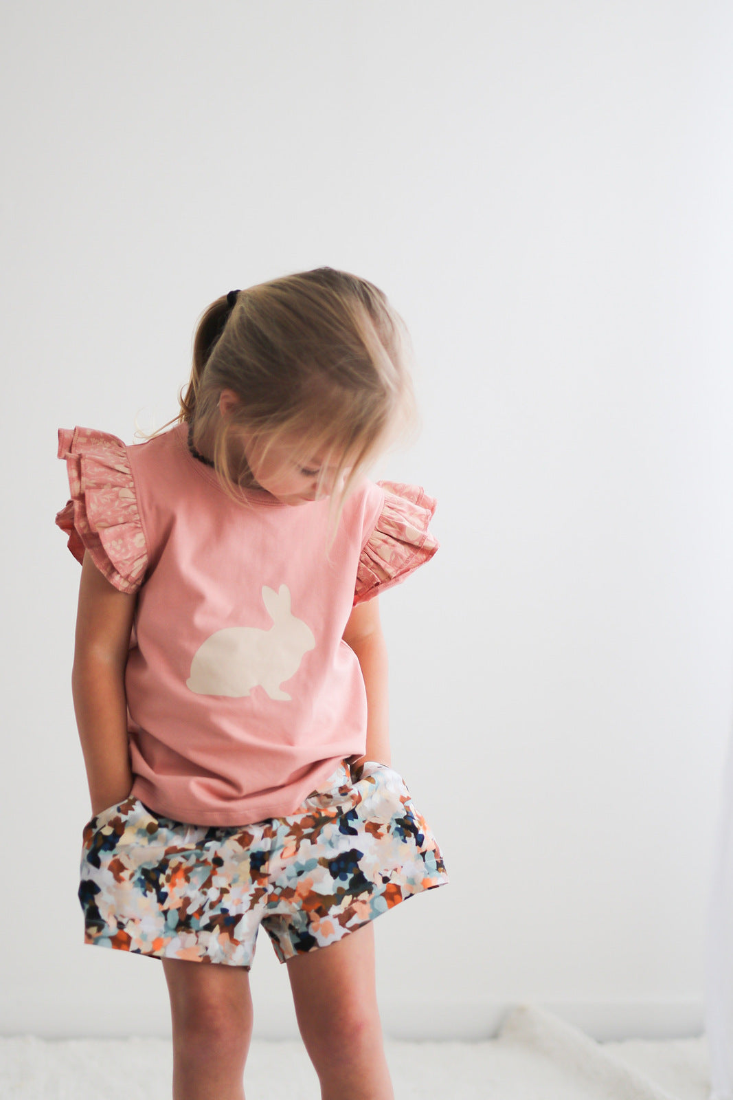 Girl wearing Doe flutter T-shirt and Delight Lyla Shorts, both by Burrow and Be