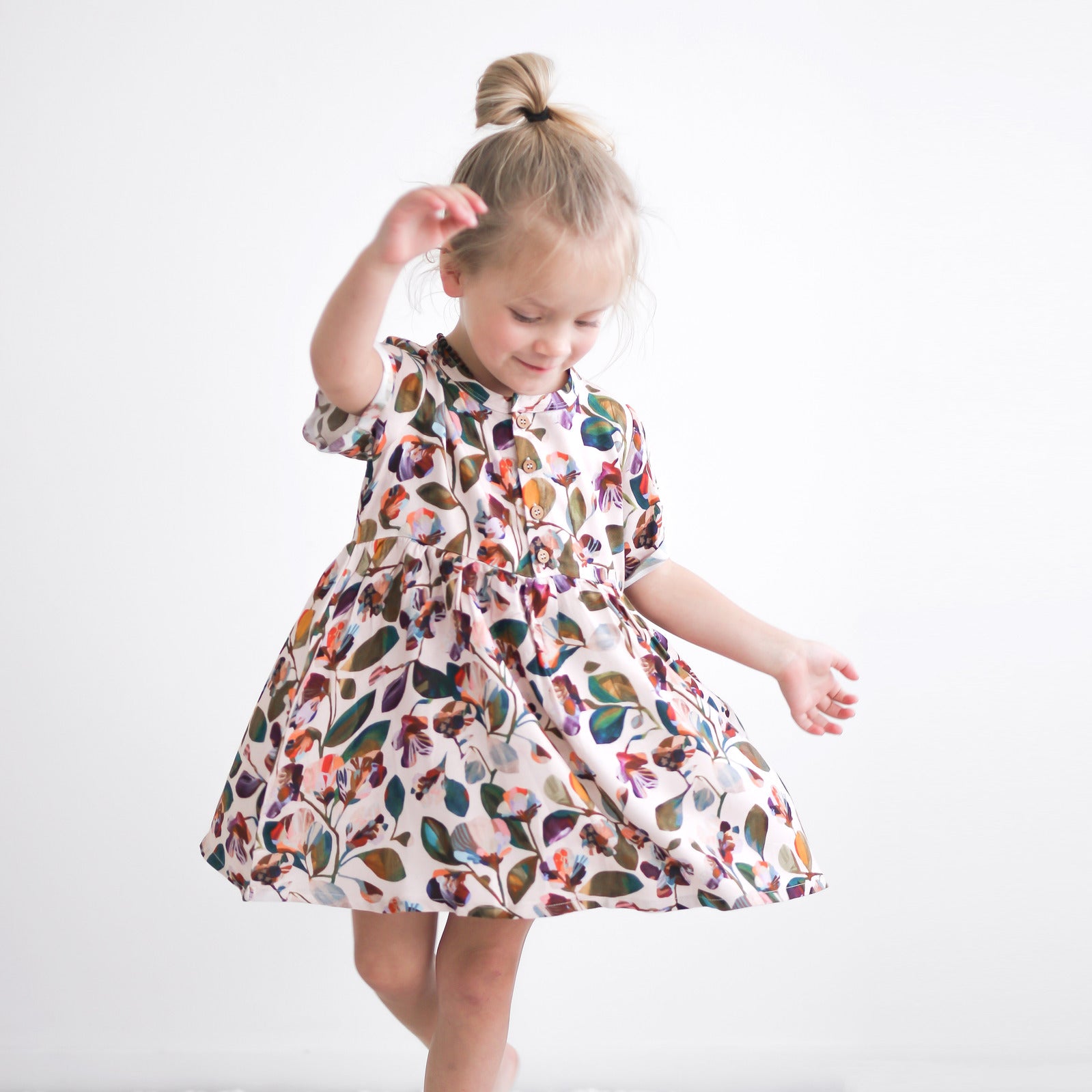 Girl wearing Garden Party Mila Dress by Burrow and Be and twirling around