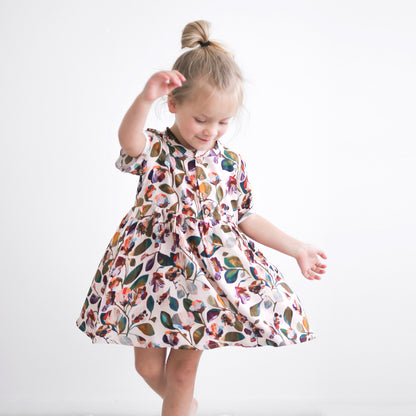 Girl wearing Garden Party Mila Dress by Burrow and Be and twirling around
