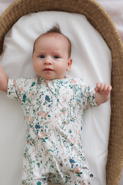 Baby in moses basket wearing Burrow and Be Wildflower Zip Suit - Short Sleeve_1