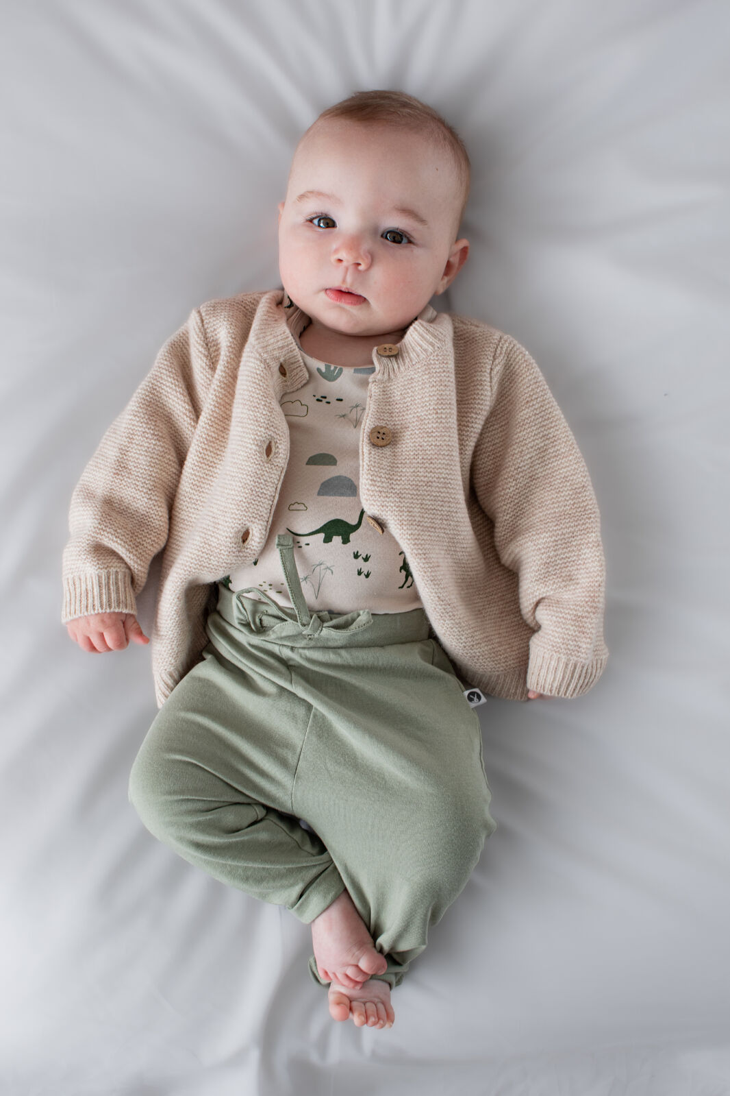 Baby wearing 100% Wool Cardigan Ecru by Burrow and Be