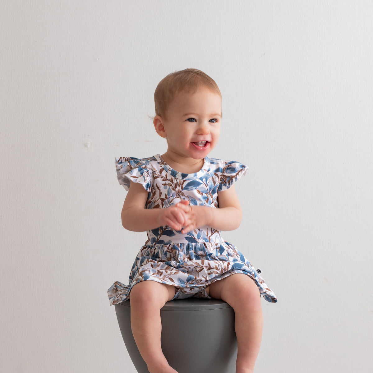 Eden Flutter Baby Dress by Burrow and Be featuring foliage and hidden bunny print