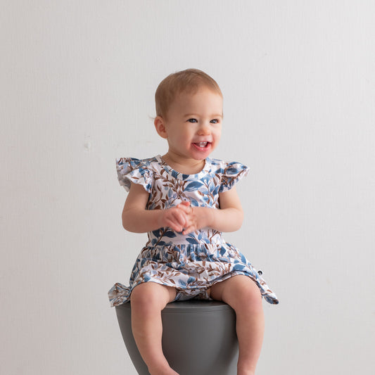 Eden Flutter Baby Dress by Burrow and Be featuring foliage and hidden bunny print