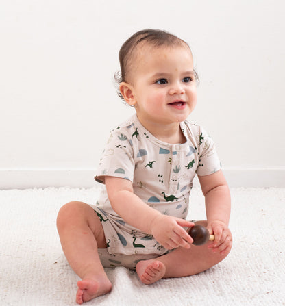 Jurassic Roam Alex Romper by Burrow and Be featuring earthy dinosaur print