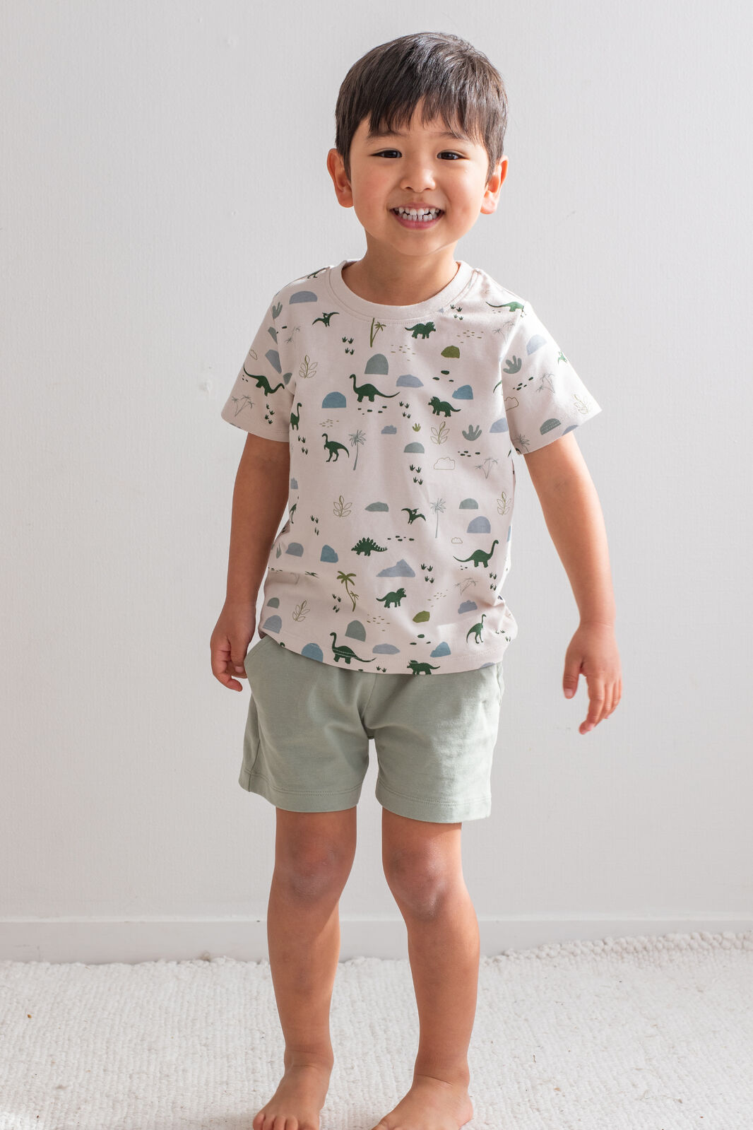Boy wearing Jurassic Roam Classic T-Shirt by Burrow and Be