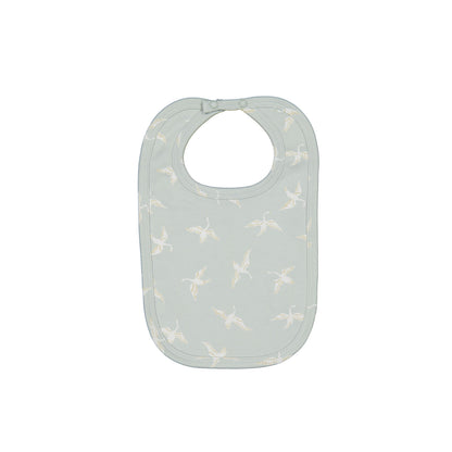 Swan Flight Snuggle Bib by Burrow and Be featuring white swans on sage