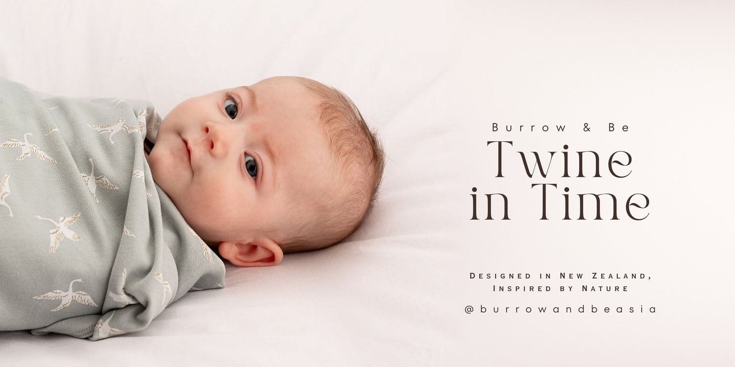 Baby wrapped in the Swan Flight Swaddle Blanket from Twine in Time, Burrow and Be Singapore